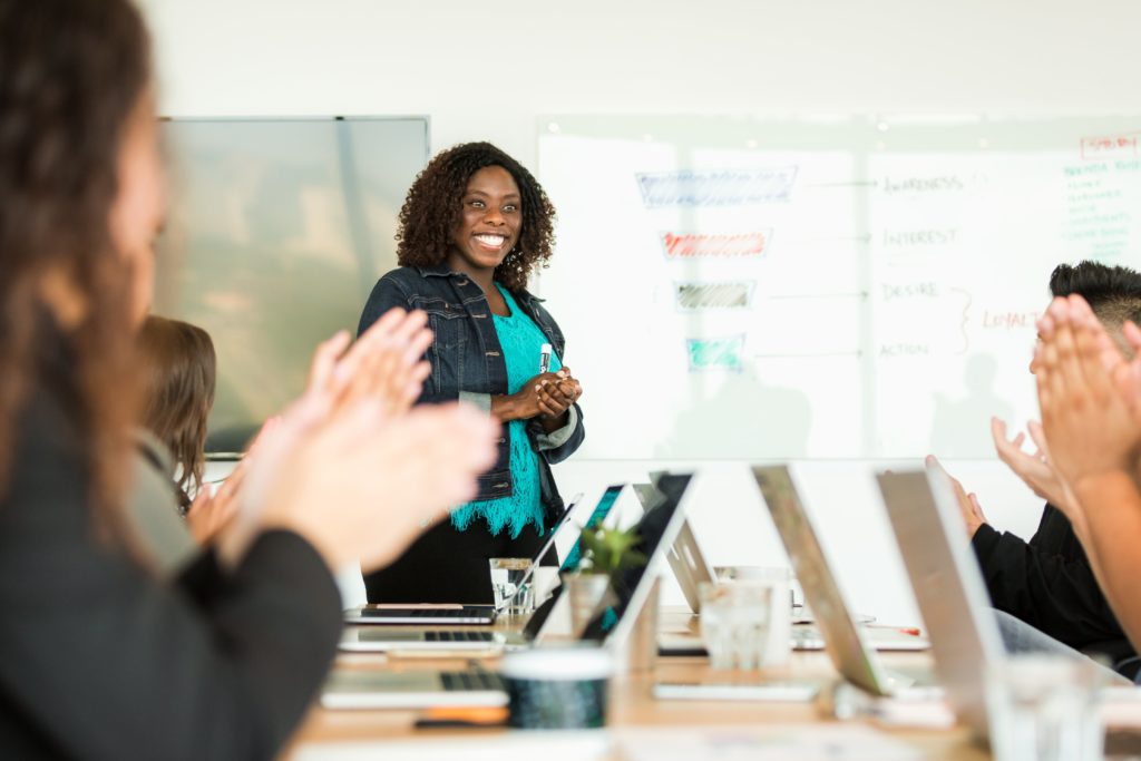 smiling woman leading meeting scaled