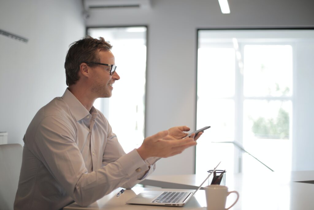 man woking with a computer and a phone