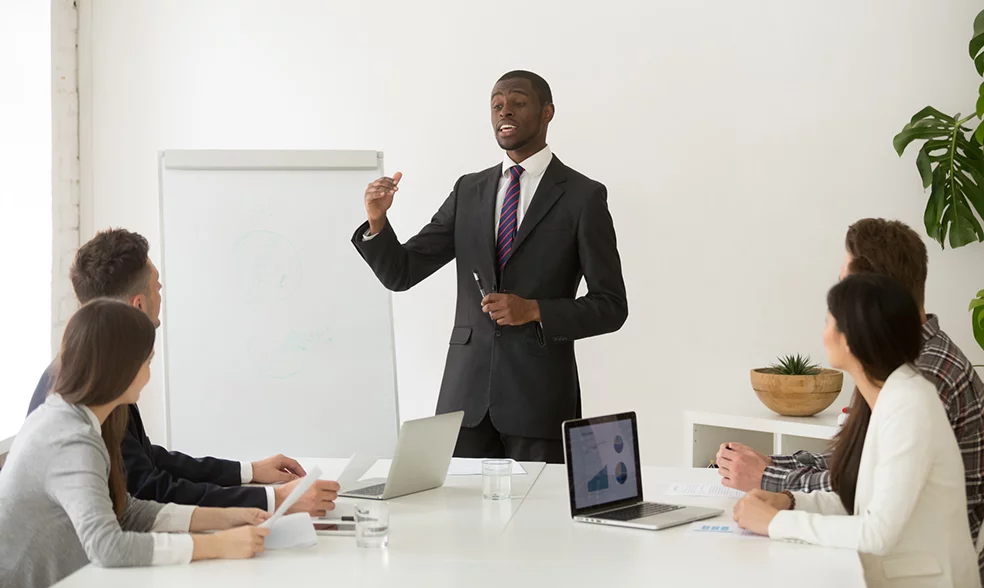confident-african-speaker-business-coach-giving-presentation-team confident-african-speaker-business-coach-giving-presentation-team