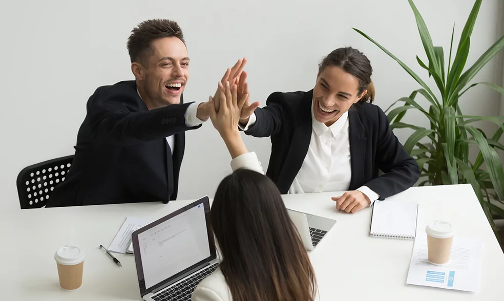 excited-millennial-office-team-giving-high-five-together-teambuilding-concept