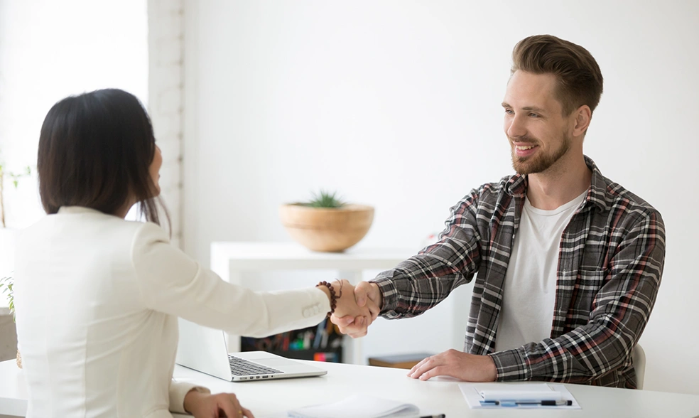 smiling-millennial-partners-handshaking-office-thanking-successful-teamwork smiling-millennial-partners-handshaking-office-thanking-successful-teamwork